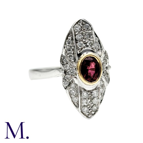 240 - A Ruby And Diamond Dress Ring in 18k white gold, the navette form set with an oval cut ruby and acce... 