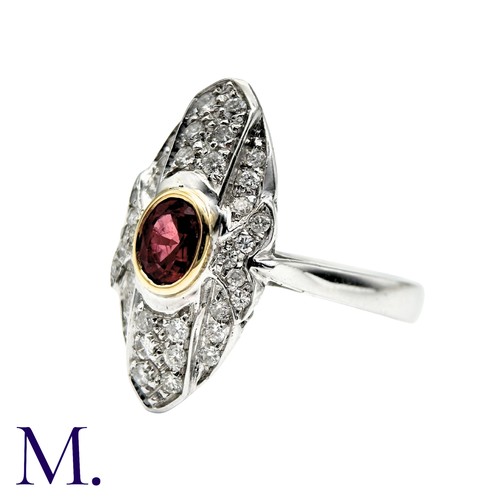 240 - A Ruby And Diamond Dress Ring in 18k white gold, the navette form set with an oval cut ruby and acce... 