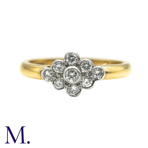 50 - A Diamond Cluster Ring inn 18 yellow gold, set with a cluster of nine round cut diamonds. Stamped 75... 