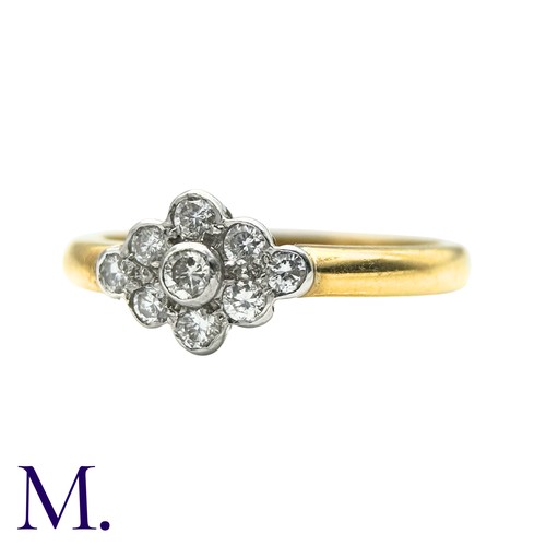 50 - A Diamond Cluster Ring inn 18 yellow gold, set with a cluster of nine round cut diamonds. Stamped 75... 