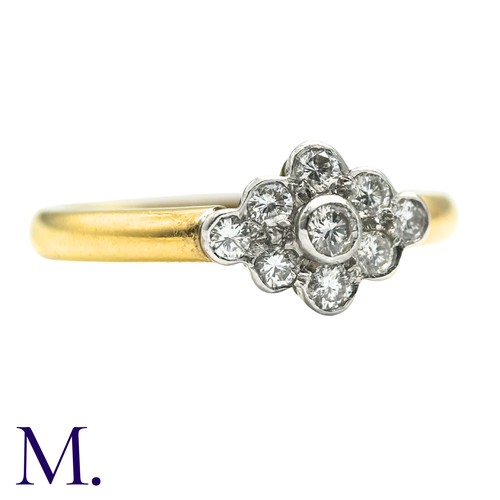 50 - A Diamond Cluster Ring inn 18 yellow gold, set with a cluster of nine round cut diamonds. Stamped 75... 