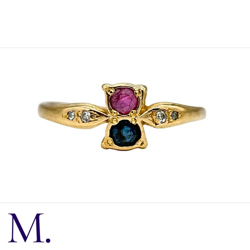 35 - A Ruby, Sapphire and Diamond Ring in  yellow gold.  Set with a single ruby and sapphire with four sm... 