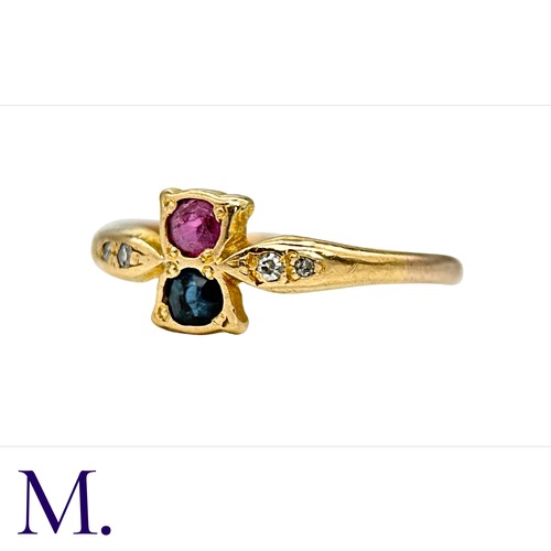 35 - A Ruby, Sapphire and Diamond Ring in  yellow gold.  Set with a single ruby and sapphire with four sm... 