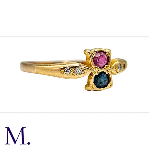 35 - A Ruby, Sapphire and Diamond Ring in  yellow gold.  Set with a single ruby and sapphire with four sm... 