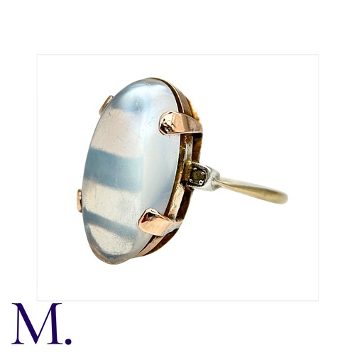 9 - A Moonstone Ring in 9K rose gold, the oval cabochon moonstone approximately 2.0x1.2cm secured with f... 