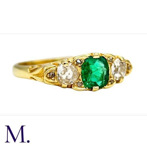 33 - An Antique Emerald and Diamond Ring in 18K yellow gold.  Set with a bright cushion cut emerald (of a... 