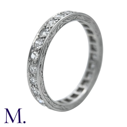 44 - A Diamond Eternity Ring with carved sides set with round cut diamonds weighing approximately 0.80ct.... 