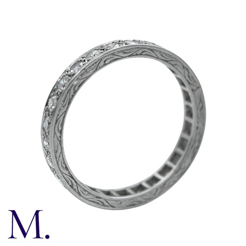 44 - A Diamond Eternity Ring with carved sides set with round cut diamonds weighing approximately 0.80ct.... 
