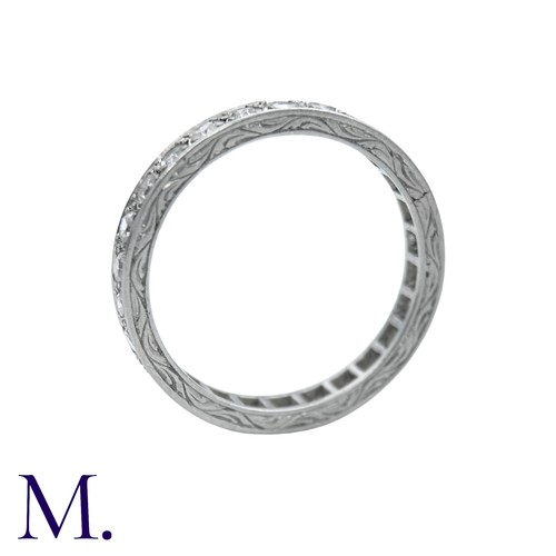 44 - A Diamond Eternity Ring with carved sides set with round cut diamonds weighing approximately 0.80ct.... 