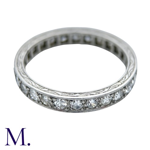 44 - A Diamond Eternity Ring with carved sides set with round cut diamonds weighing approximately 0.80ct.... 