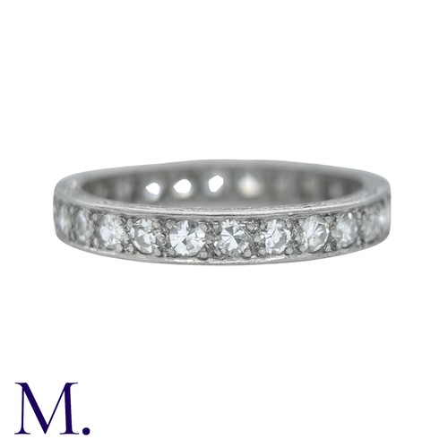 44 - A Diamond Eternity Ring with carved sides set with round cut diamonds weighing approximately 0.80ct.... 