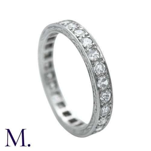 44 - A Diamond Eternity Ring with carved sides set with round cut diamonds weighing approximately 0.80ct.... 