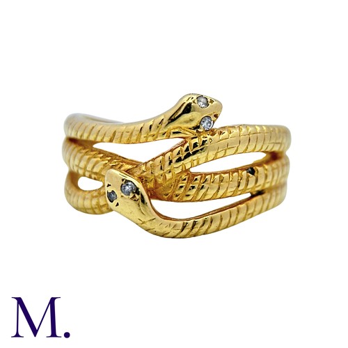 191 - A Diamond Snake Ring in 18k yellow gold, designed as coiled snakes, set to the eyes with round cut d... 