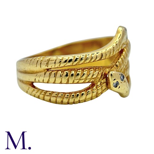 191 - A Diamond Snake Ring in 18k yellow gold, designed as coiled snakes, set to the eyes with round cut d... 