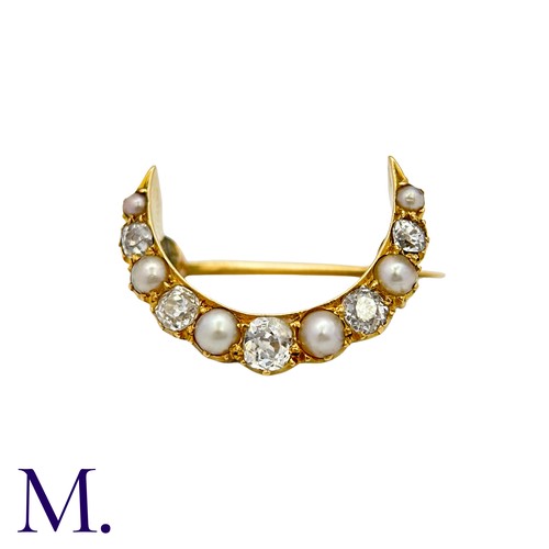 222 - A Pearl And Diamond Crescent Brooch in yellow gold, the crescent form set with alternating pearls an... 