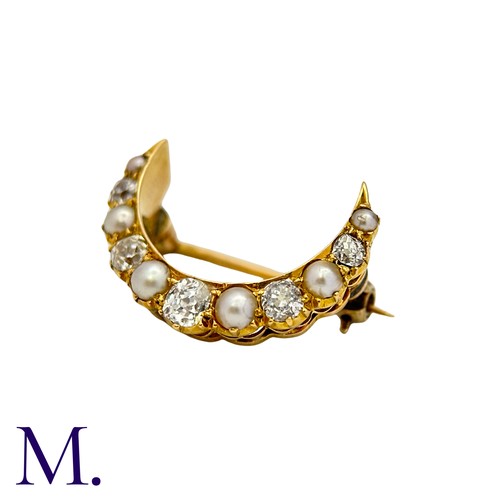 222 - A Pearl And Diamond Crescent Brooch in yellow gold, the crescent form set with alternating pearls an... 