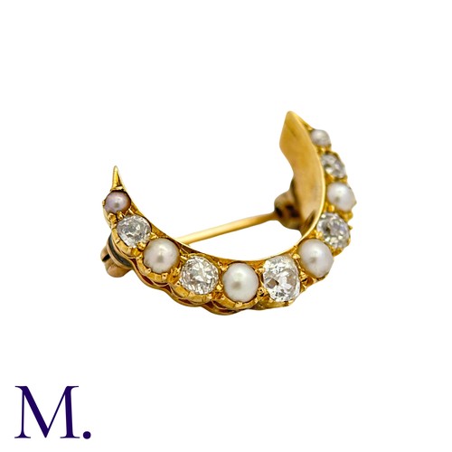222 - A Pearl And Diamond Crescent Brooch in yellow gold, the crescent form set with alternating pearls an... 