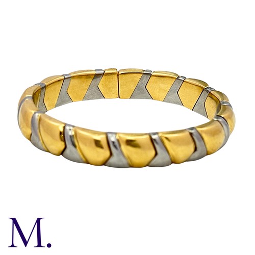 105 - BULGARI. An Alveare Bangle in 18k yellow gold and steel comprising a series of interlocking links to... 