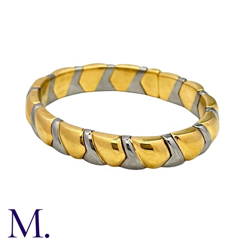 105 - BULGARI. An Alveare Bangle in 18k yellow gold and steel comprising a series of interlocking links to... 