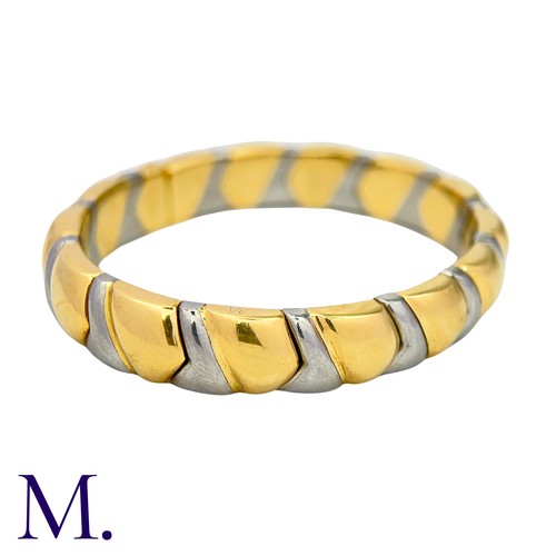 105 - BULGARI. An Alveare Bangle in 18k yellow gold and steel comprising a series of interlocking links to... 