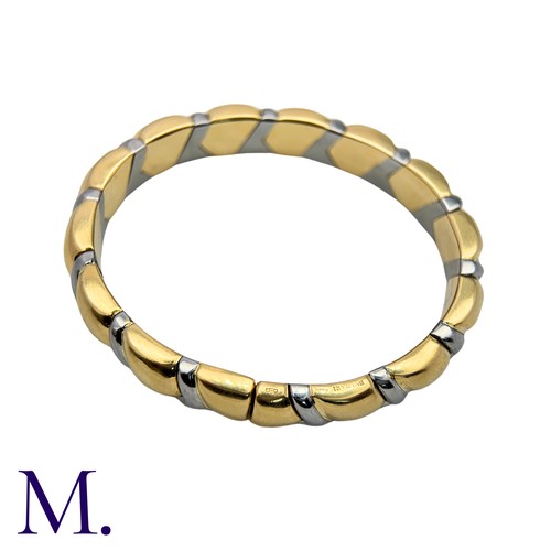105 - BULGARI. An Alveare Bangle in 18k yellow gold and steel comprising a series of interlocking links to... 