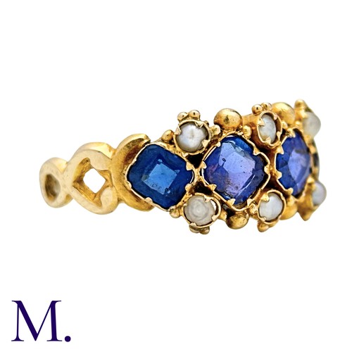 55 - A Sapphire And Pearl Ring in yellow gold, set with four square cushion shaped sapphires punctuated b... 