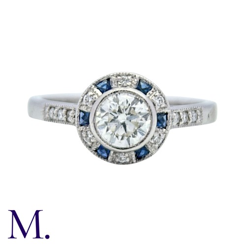 229 - A Diamond And Sapphire Target Cluster Ring in 18k white gold, set with a principal round cut diamond... 