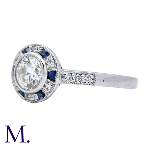 229 - A Diamond And Sapphire Target Cluster Ring in 18k white gold, set with a principal round cut diamond... 