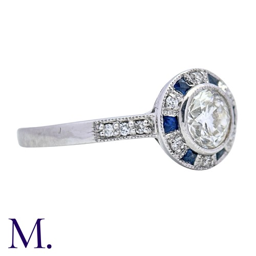 229 - A Diamond And Sapphire Target Cluster Ring in 18k white gold, set with a principal round cut diamond... 