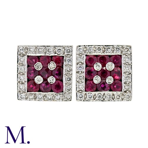 51 - A Pair Of Ruby And Diamond Earrings in 18k yellow gold and platinum each set with three rows of roun... 