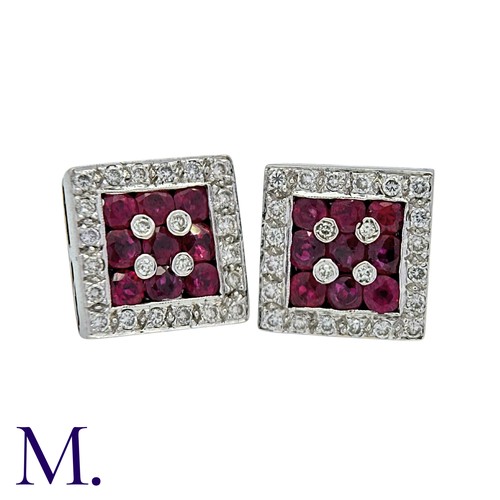 51 - A Pair Of Ruby And Diamond Earrings in 18k yellow gold and platinum each set with three rows of roun... 