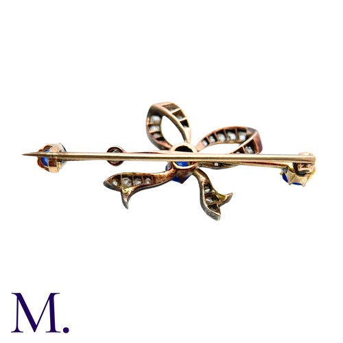 236 - An Antique Sapphire And Diamond Bow Brooch in yellow gold and silver, comprising a diamond set bow o... 