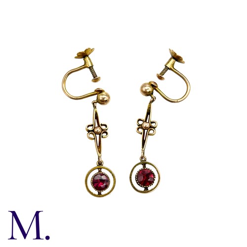 213 - A Pair Of Garnet Drop Earrings in 9k yellow gold, comprising an articulated scrolling bar suspending... 
