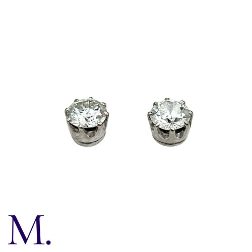 56 - A Pair Of Diamond Stud Earrings in platinum and white gold, each comprising a round cut diamond of a... 