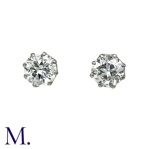 56 - A Pair Of Diamond Stud Earrings in platinum and white gold, each comprising a round cut diamond of a... 