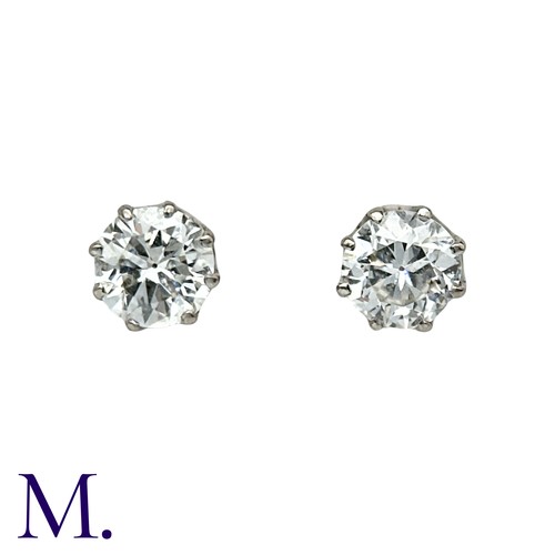 56 - A Pair Of Diamond Stud Earrings in platinum and white gold, each comprising a round cut diamond of a... 
