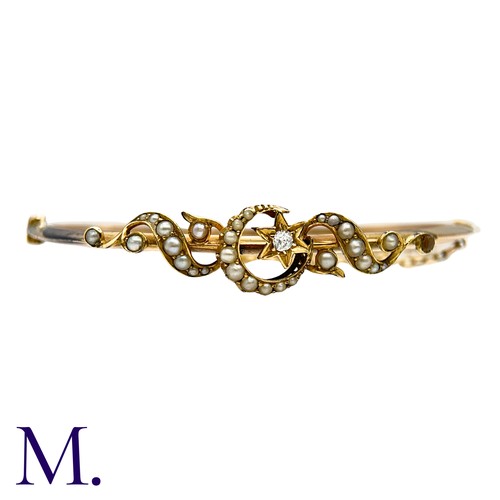 18 - A Pearl And Diamond Bangle  in yellow gold, with pearl set scrolling motifs, a pearl set crescent an... 