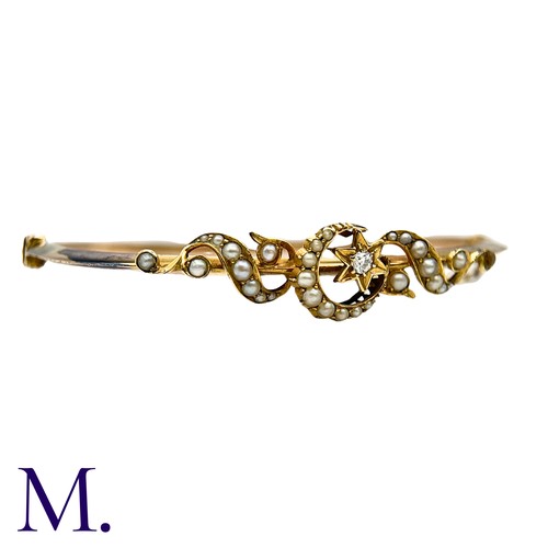18 - A Pearl And Diamond Bangle  in yellow gold, with pearl set scrolling motifs, a pearl set crescent an... 