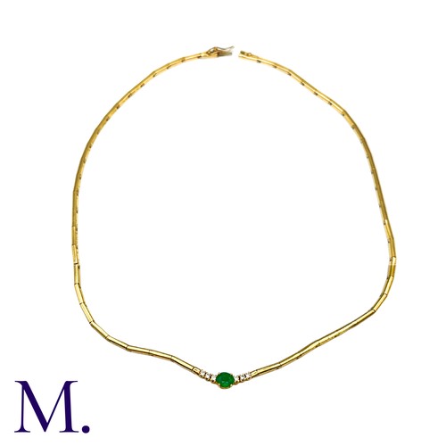 45 - An Emerald And Diamond Necklace in yellow gold, set with a principal oval cut emerald accented eithe... 