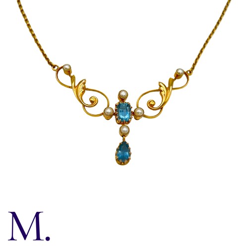 40 - An Aquamarine And Pearl Necklace in 15k yellow gold, set with a step cut aquamarine and pearls suspe... 