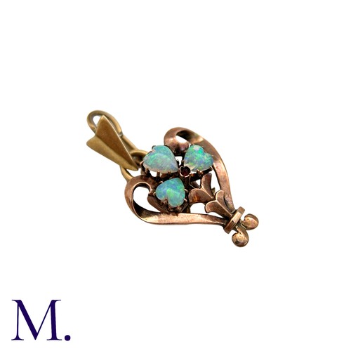 207 - An Opal And Ruby Pendant in 8k yellow gold set with three heart shape cabochon opals and a cabochon ... 