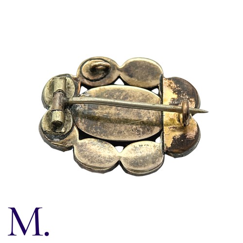 27 - An Amethyst And Glass Brooch in yellow gold, comprising a cluster of oval cut amethyst around a glas... 