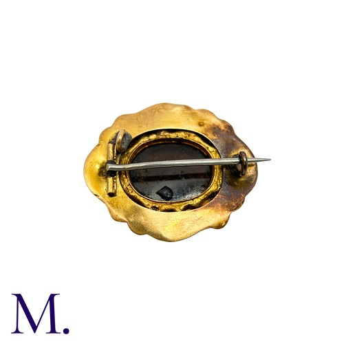 15 - A Sardonyx Mourning Brooch in yellow gold, set with a carved hardstone depicting a Forget-Me-Knot fl... 