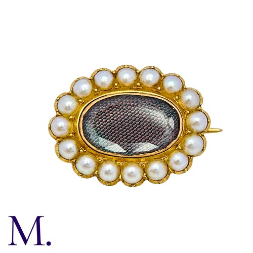 10 - A Pearl And Hairwork Mourning Brooch in yellow gold, set with woven hairwork within a pearl border, ... 