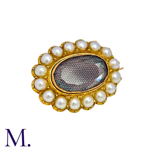 10 - A Pearl And Hairwork Mourning Brooch in yellow gold, set with woven hairwork within a pearl border, ... 