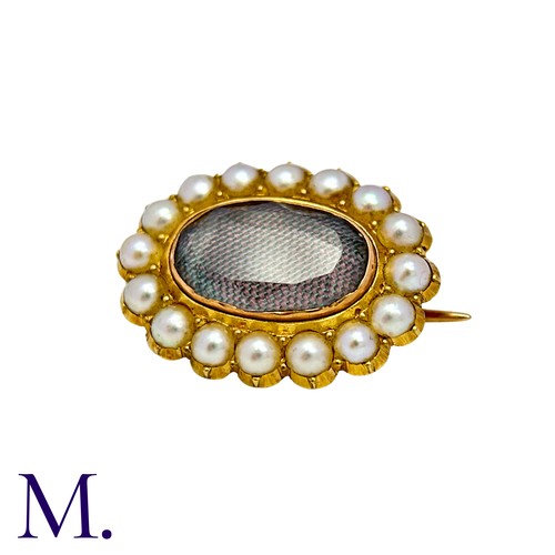 10 - A Pearl And Hairwork Mourning Brooch in yellow gold, set with woven hairwork within a pearl border, ... 