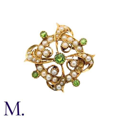 214 - A Peridot And Pearl Brooch in 15k yellow gold, the circular form set with pearls and peridot with sc... 