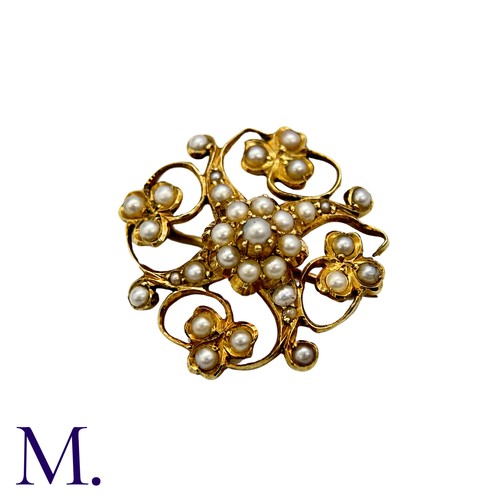 215 - A Pearl Brooch in 15k yellow gold, the openwork scrolling and foliate form set with pearls. Stamped ... 