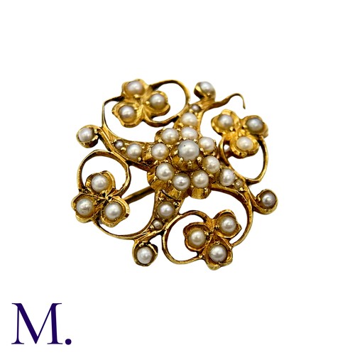 215 - A Pearl Brooch in 15k yellow gold, the openwork scrolling and foliate form set with pearls. Stamped ... 