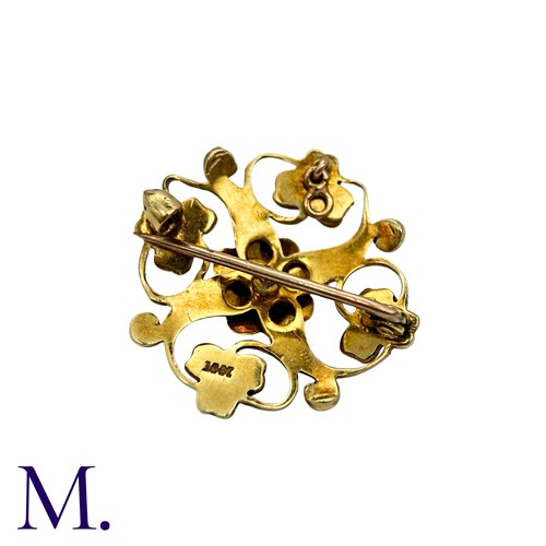 215 - A Pearl Brooch in 15k yellow gold, the openwork scrolling and foliate form set with pearls. Stamped ... 